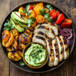 AIP-friendly meal with grilled chicken, vegetables, and avocado dip